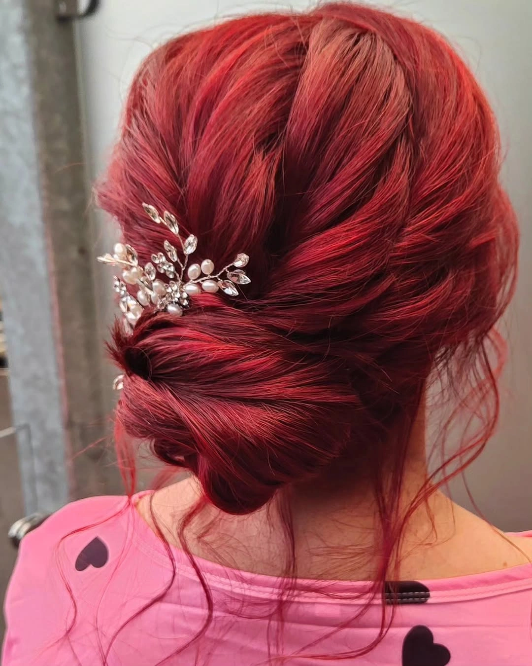bridesmaid hairstyling Bold Ruby Red Textured Low Bun with Sparkling Accent