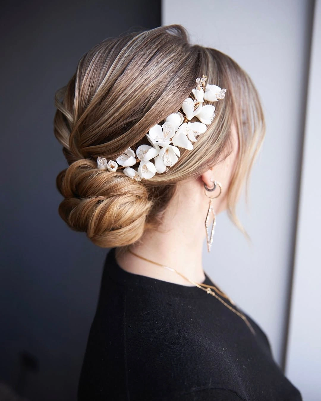 bridesmaid hairstyling Elegant Floral Low Chignon with Soft Blonde Dimension