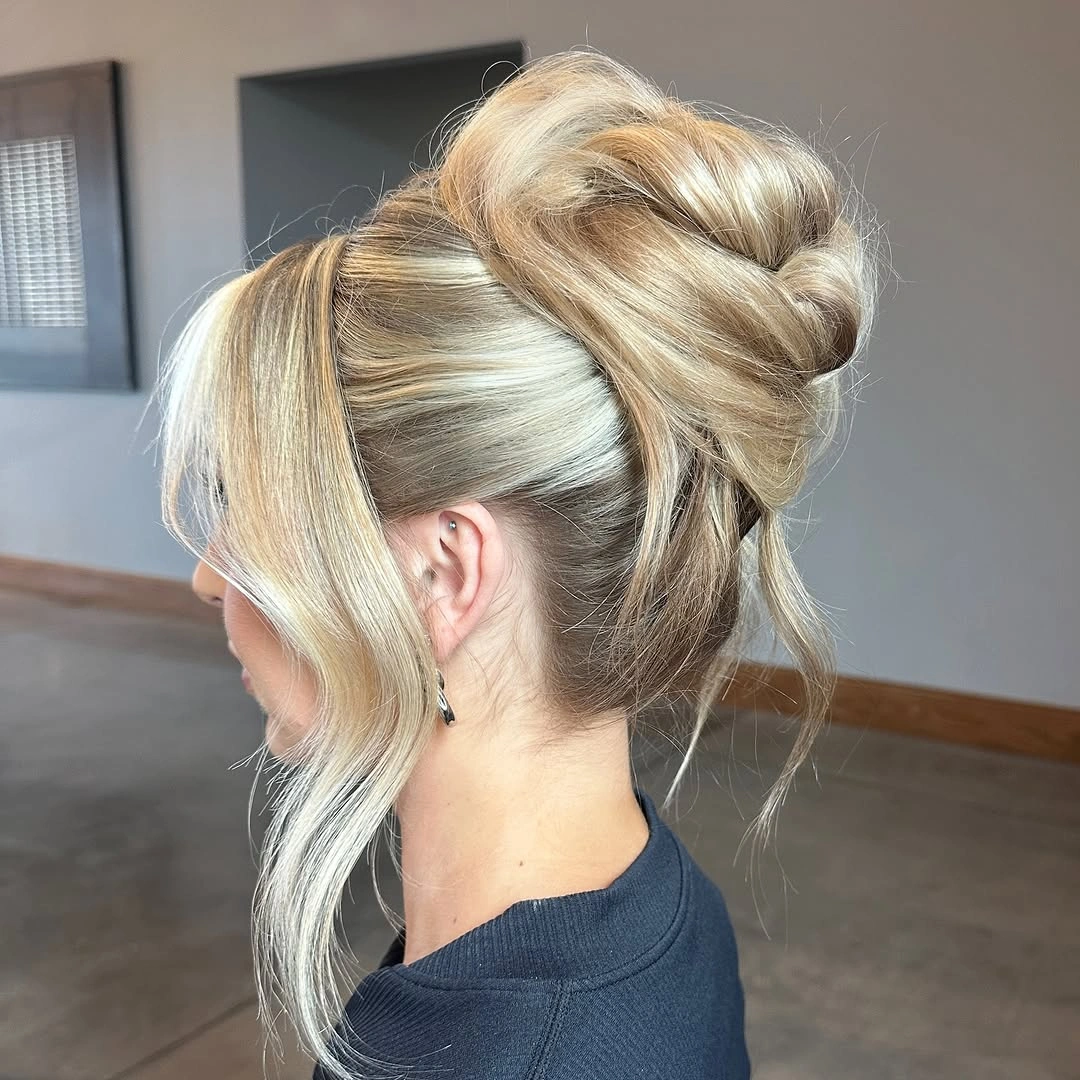 bridesmaid hairstyling Modern High Textured Bun with Statement Face-Framing Pieces