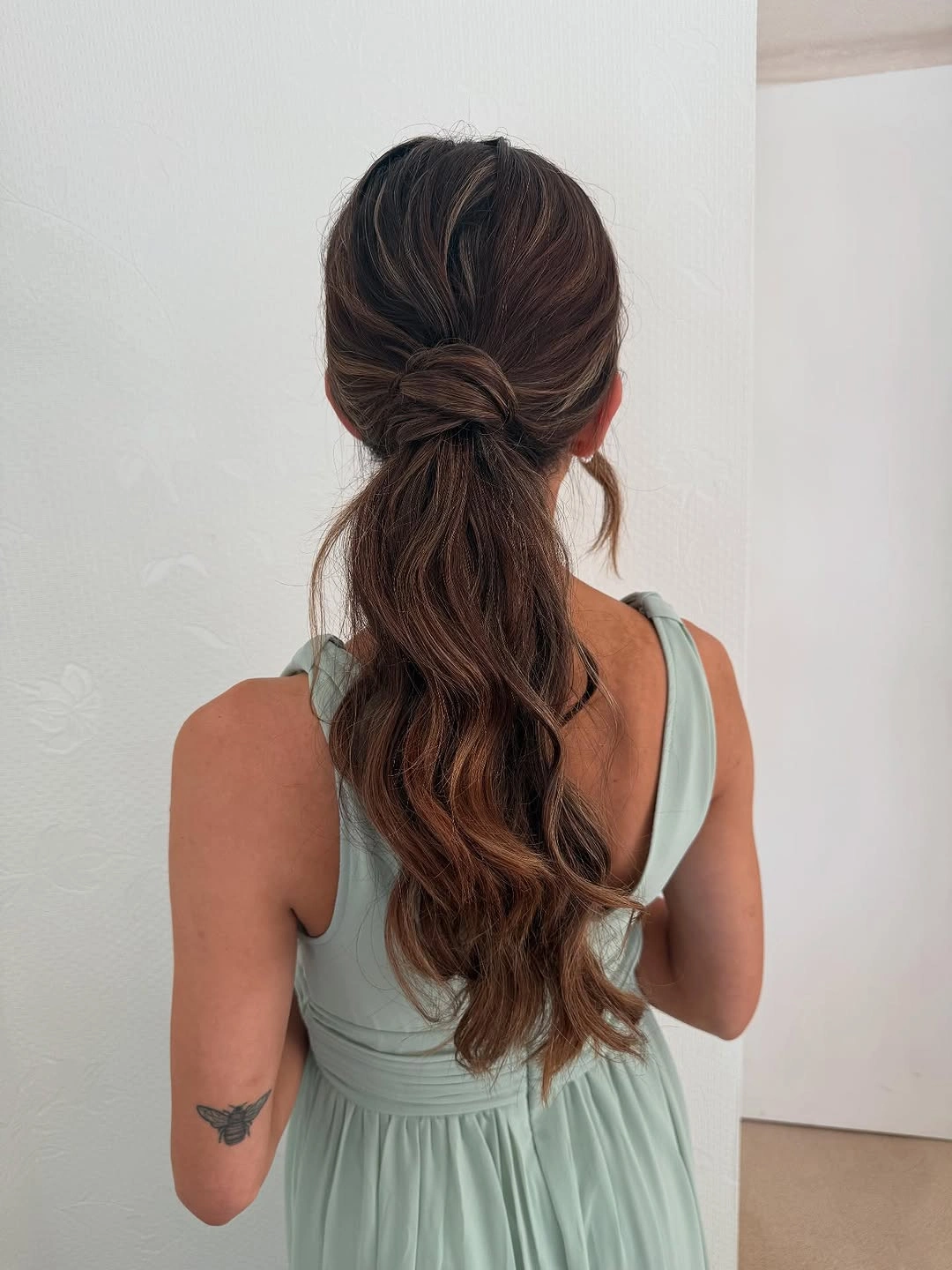 bridesmaid hairstyling Low Wrapped Ponytail with Relaxed Romantic Waves