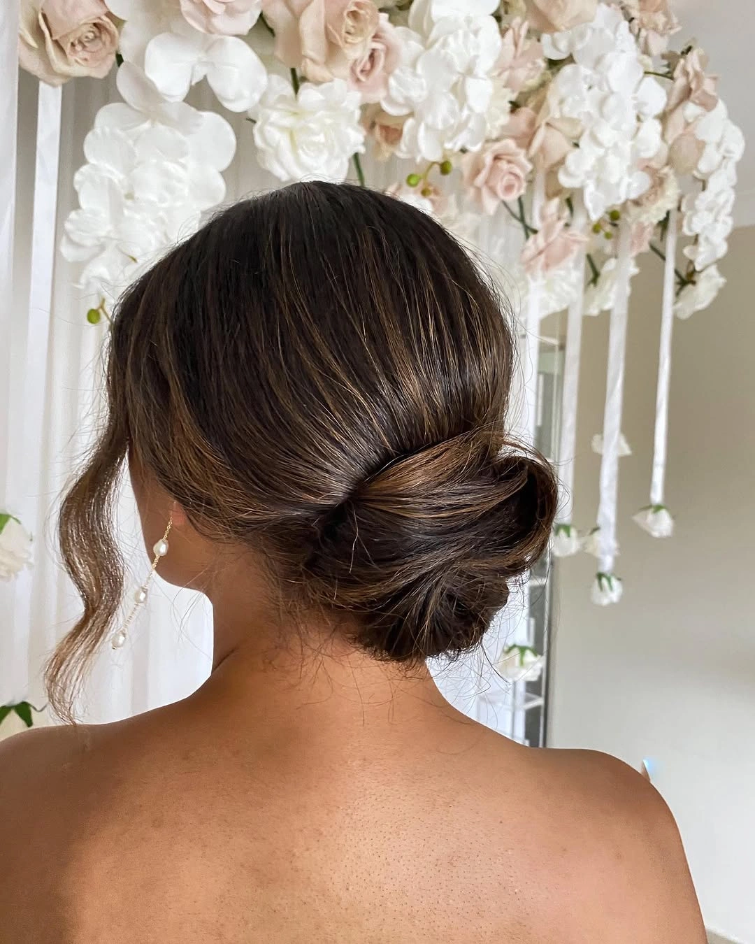 bridesmaid hairstyling Low Twisted Chignon with Timeless Bridal Sophistication
