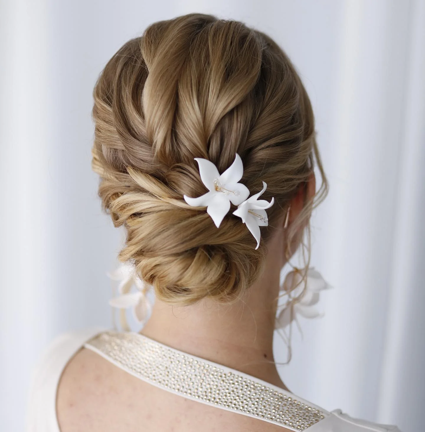 bridesmaid hairstyling Romantic Textured Blonde Chignon with Floral Accents