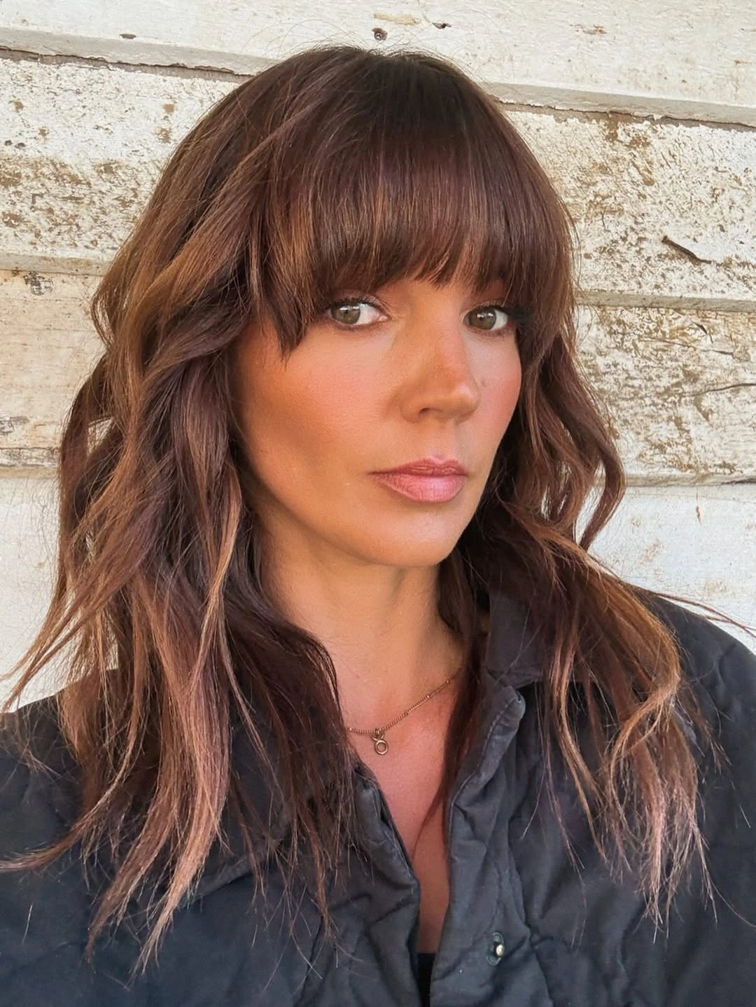 dimensional brunette hair color Wavy Brunette Shag With Full Bangs