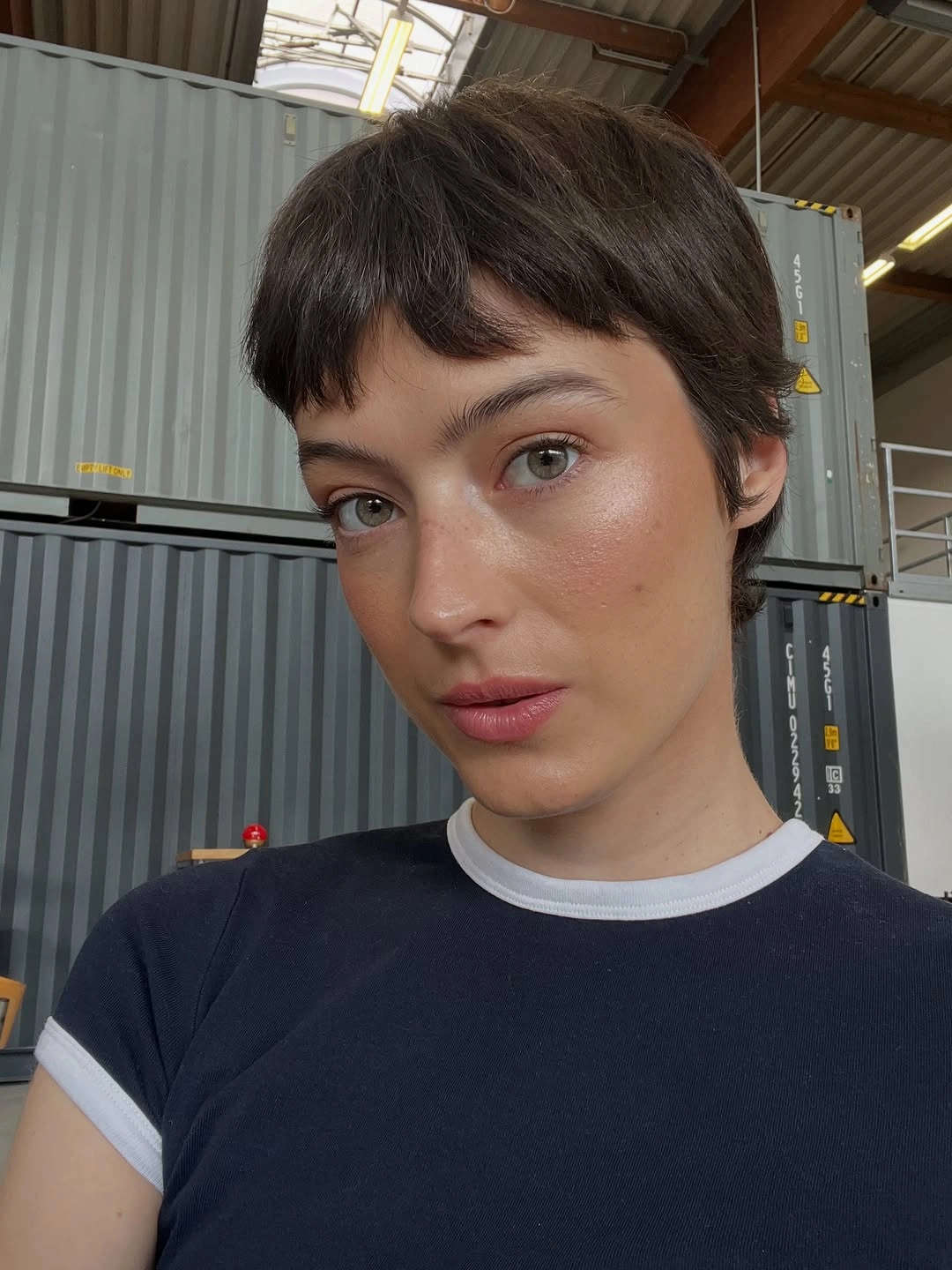 dimensional brunette hair color Short Textured Brunette Pixie With Soft Bangs