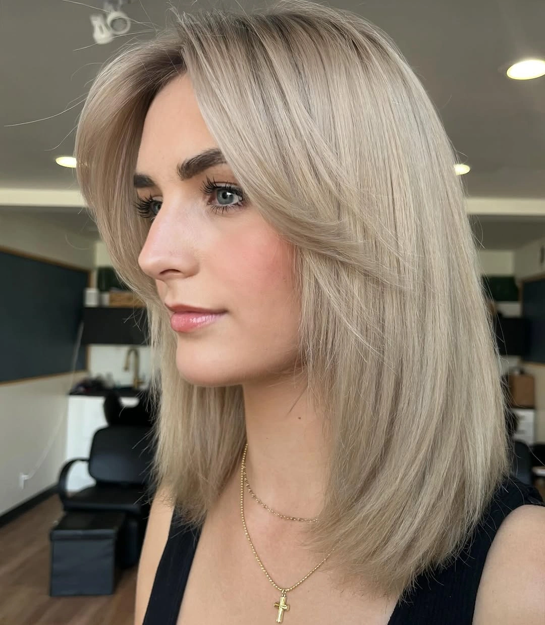 dirty blonde hair color Champagne Dirty Blonde Midi Cut With Feathered Layers
