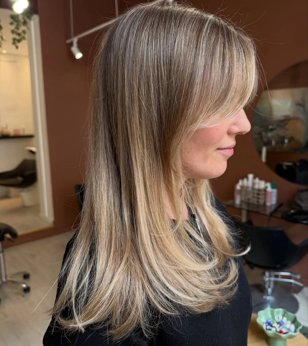 dirty blonde hair color Layered Dirty Blonde With Feathered Curtain Bangs