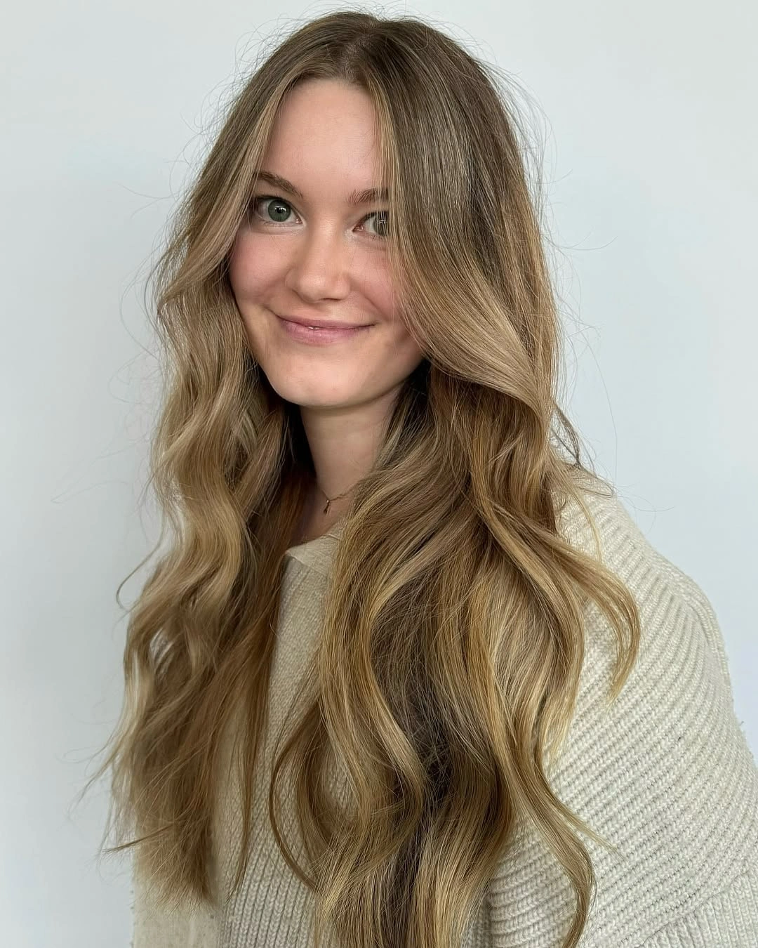 dirty blonde hair color Long Beige Dirty Blonde Waves With Soft Shadow Roots