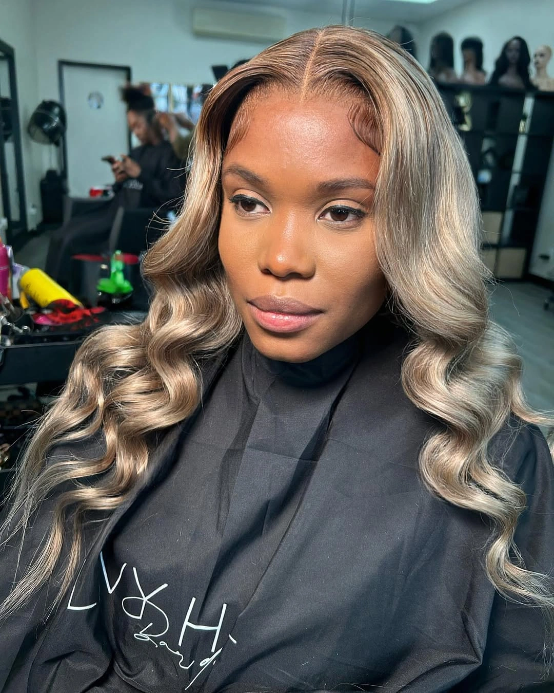 fall hair colors for black women 2026 Smoky Mushroom Blonde Waves With Luxurious Dimension