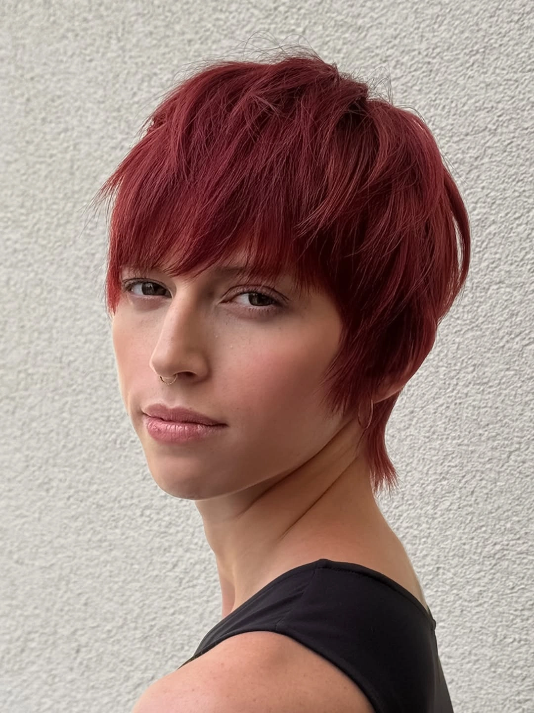 Fall hairstyles for short hair 2026 Deep Auburn Pixie With Soft Feathered Layers