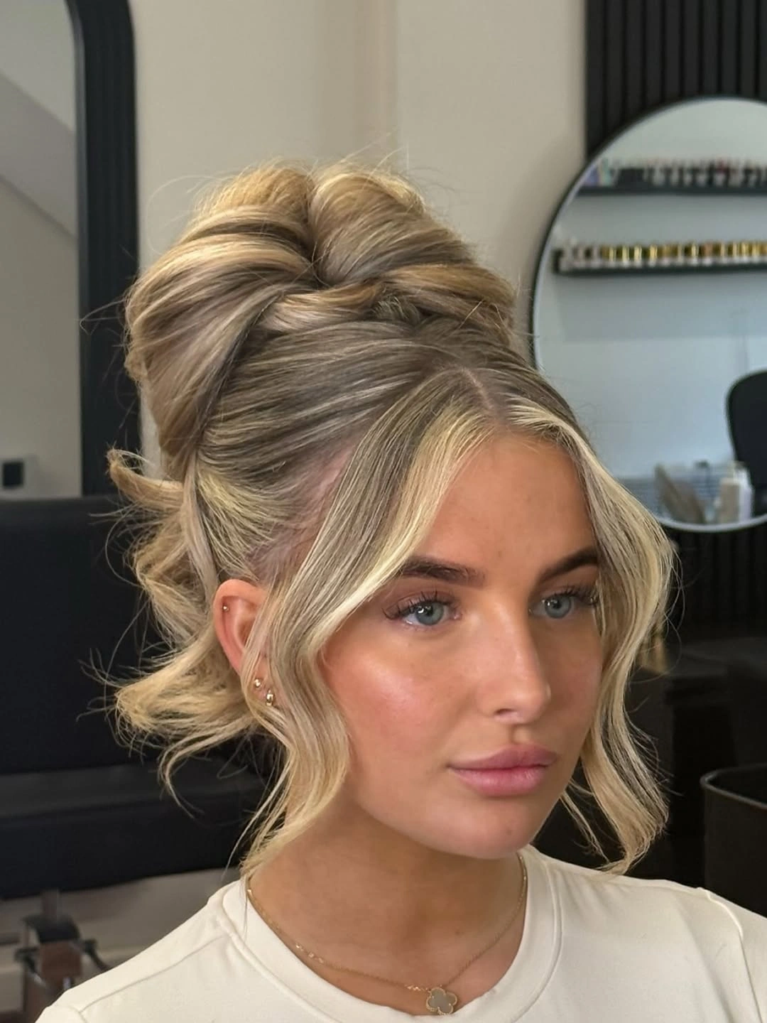 Fall hairstyles for wedding guests 2026 Elegant Blonde French Twist With Soft Curtain Layers