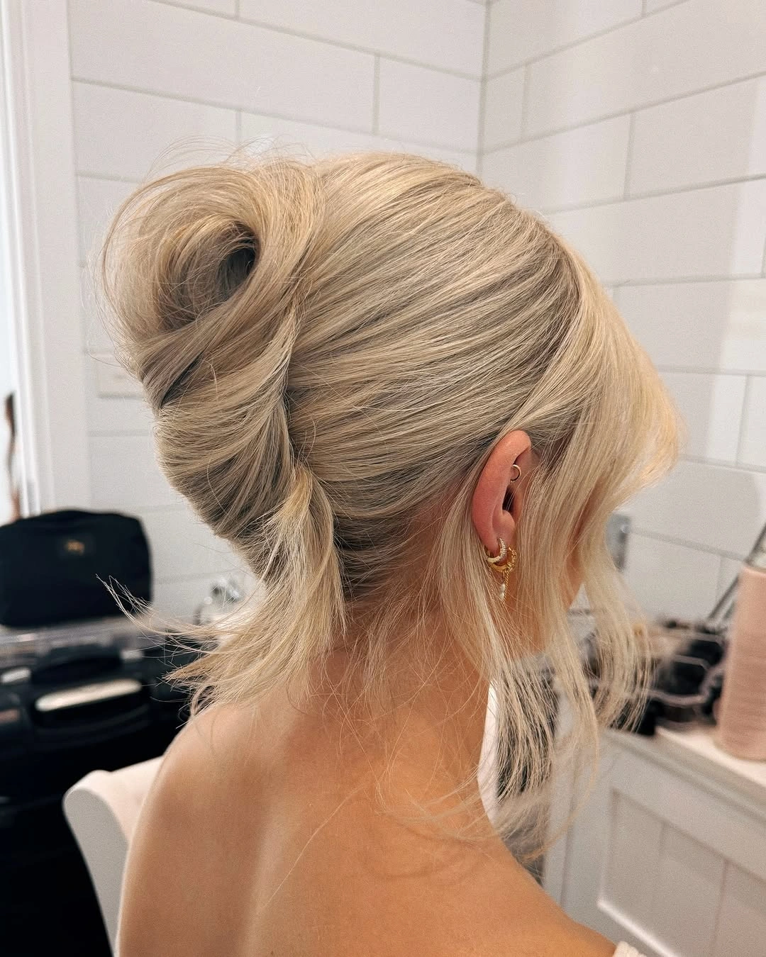 Fall hairstyles for wedding guests 2026 Minimalist French Roll With Soft Platinum Finish