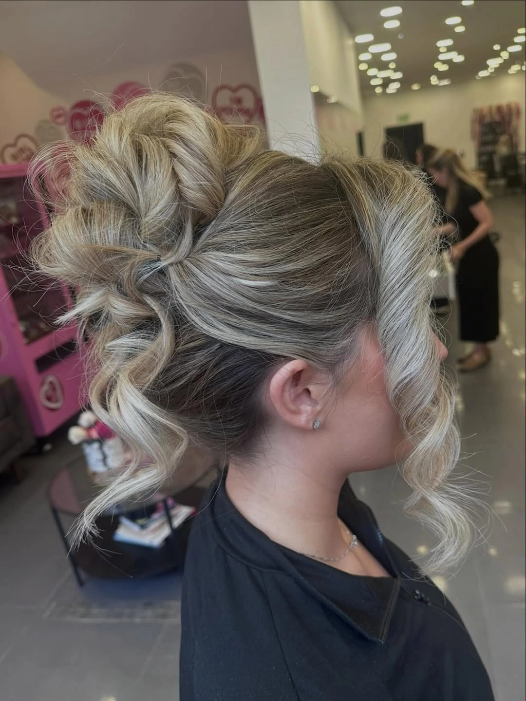 Fall hairstyles for wedding guests 2026 Romantic Twisted Bun With Statement Blonde Ribbon Curl