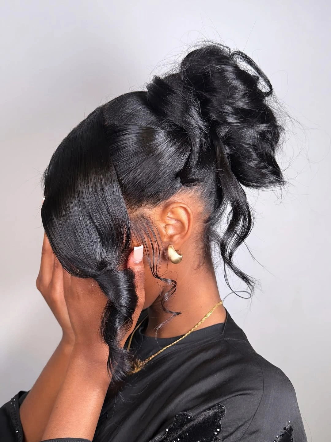 Fall hairstyles for wedding guests 2026 Sleek Ebony Updo With Dramatic Side Sweep
