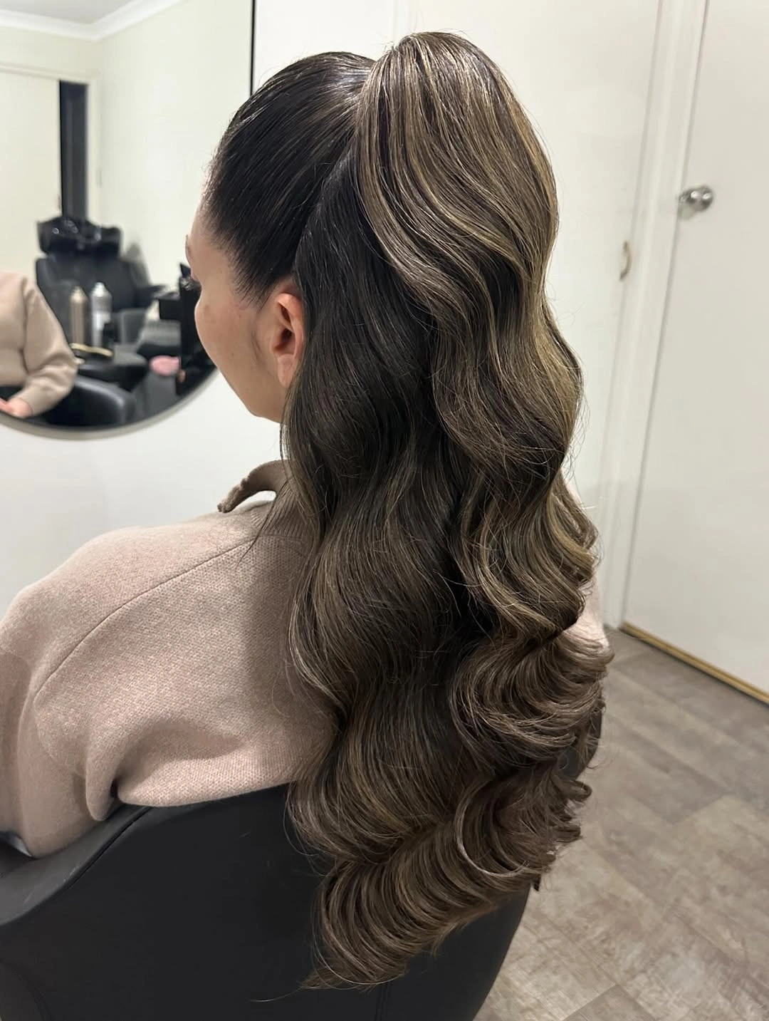 Fall hairstyles for wedding guests 2026 Voluminous High Ponytail With Soft Espresso Waves