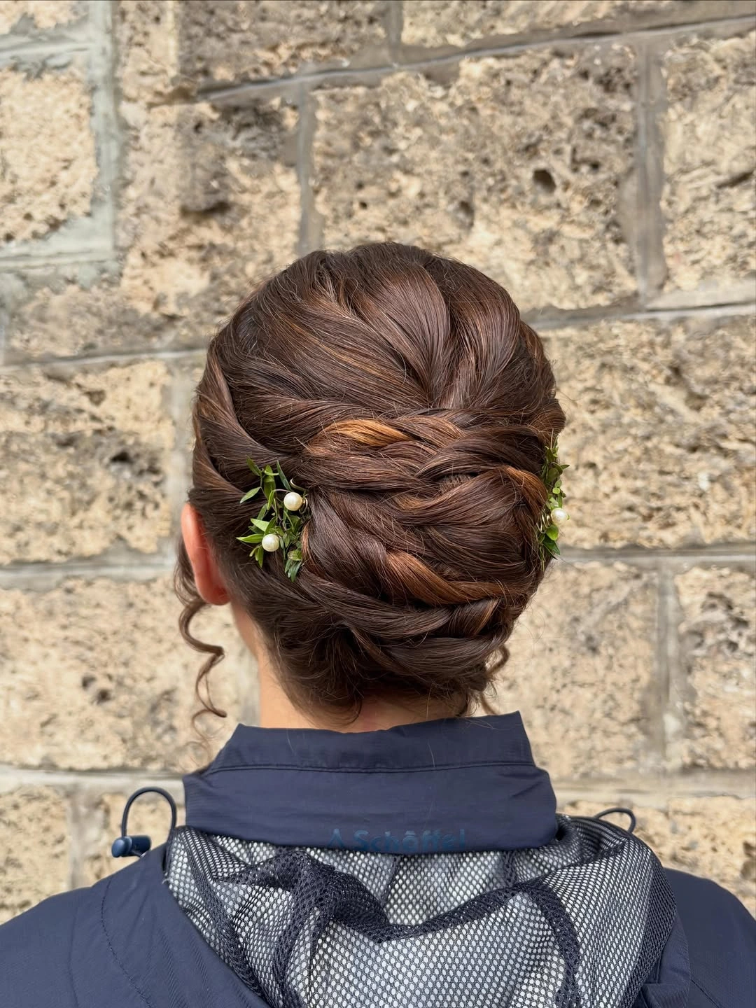 Fall hairstyles for wedding guests 2026 Elegant Braided Chignon With Romantic Botanical Details