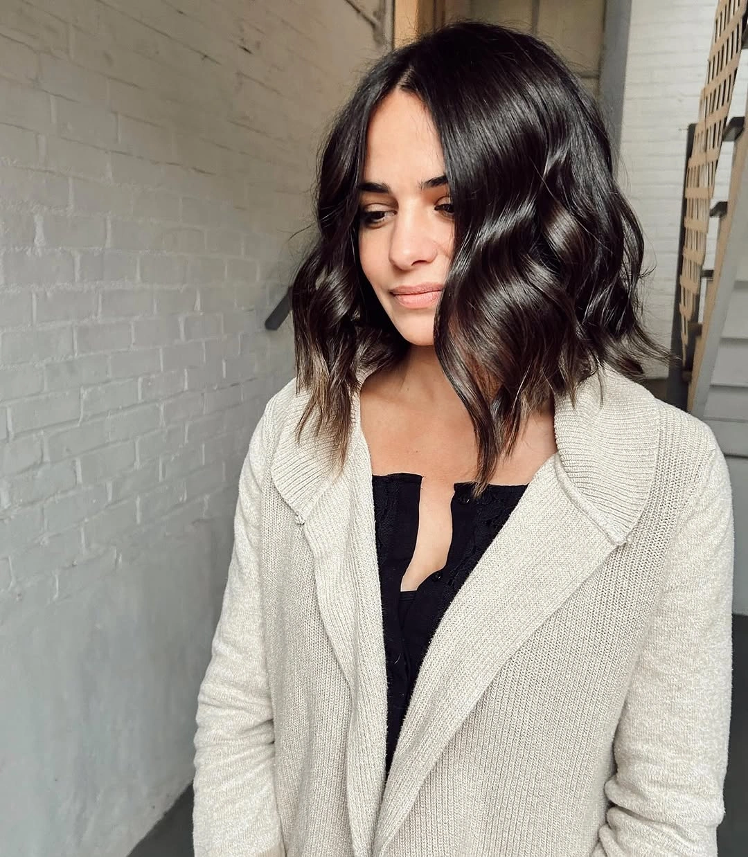 fall medium haircuts 2026 Soft Wavy Collarbone Bob with a Glossy Espresso Finish