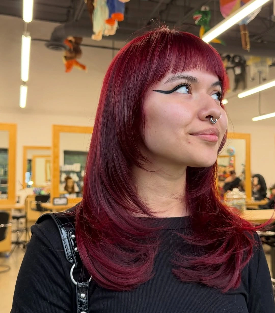 fall medium haircuts 2026 Deep Burgundy Blowout with Full Micro Bangs