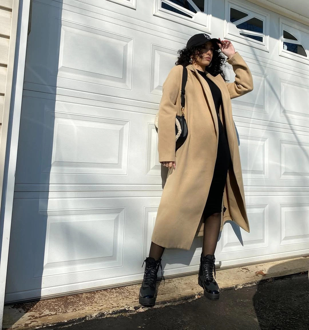 fall pregnancy outfits 2026 A Camel Coat and Black Dress Never Go Out of Style