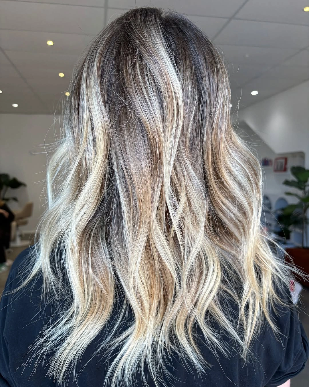 Hair Lowlights: Color Ideas and Inspiration Dimensional Blonde Waves With Soft Root Depth