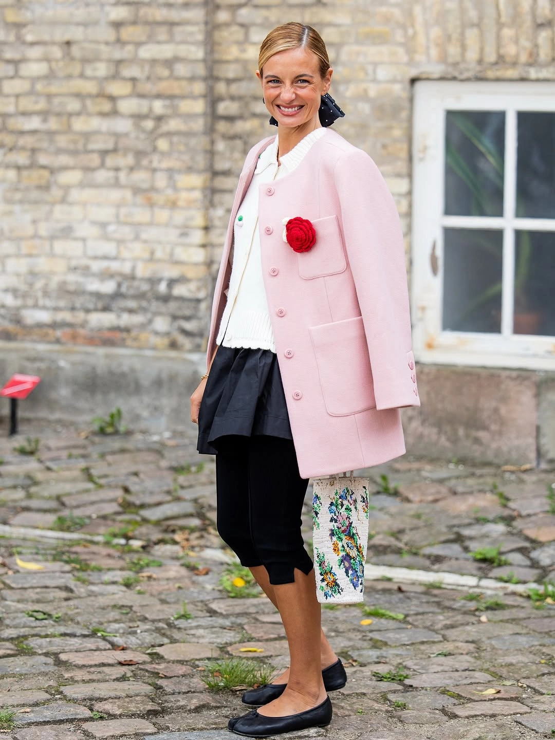 September fashion trends 2026 Pink Coat With Dark Skirt And Ballet Flats