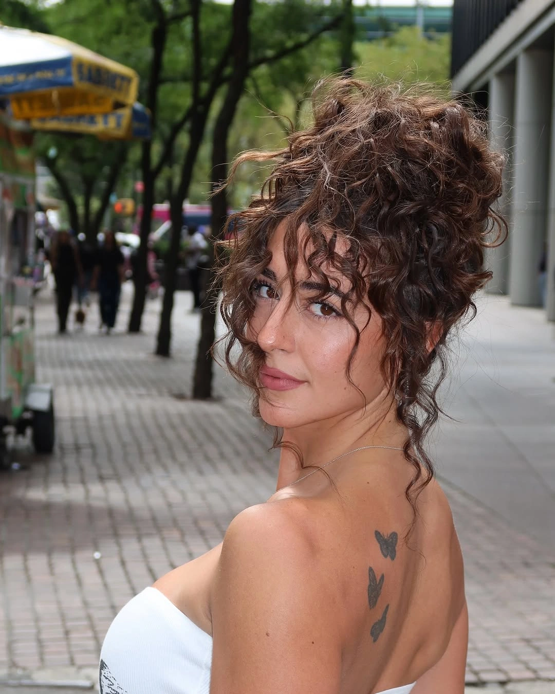 September hairstyles ideas 2026 Curly Updo With Loose Face Tendrils