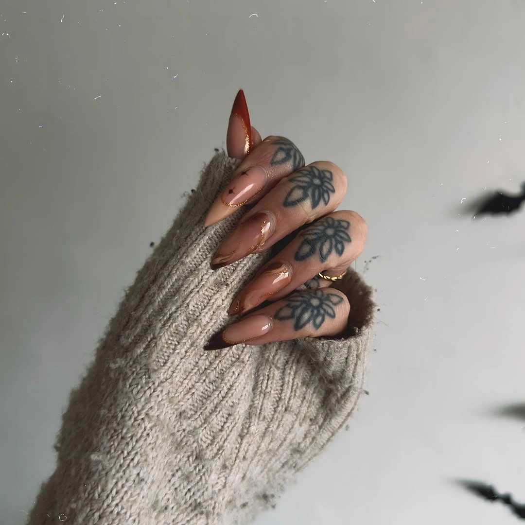 September nail art ideas 2026 Smoky Brown Almond Nails With Blue Floral Art