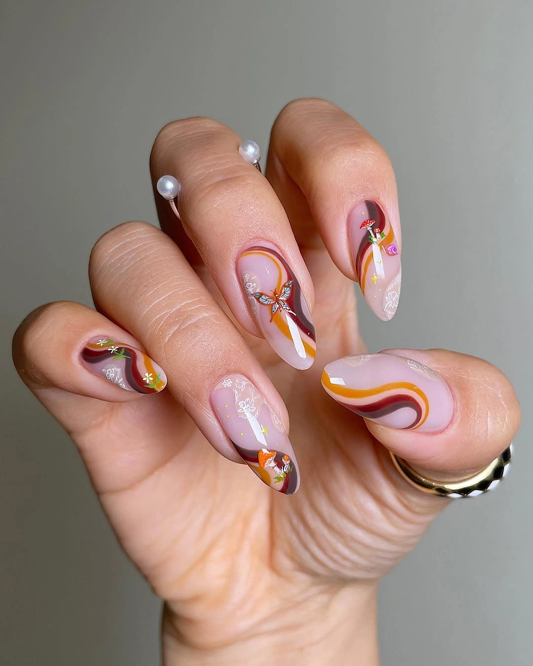 September nail art ideas 2026 Pastel Wave Nails With Orange And Plum Lines
