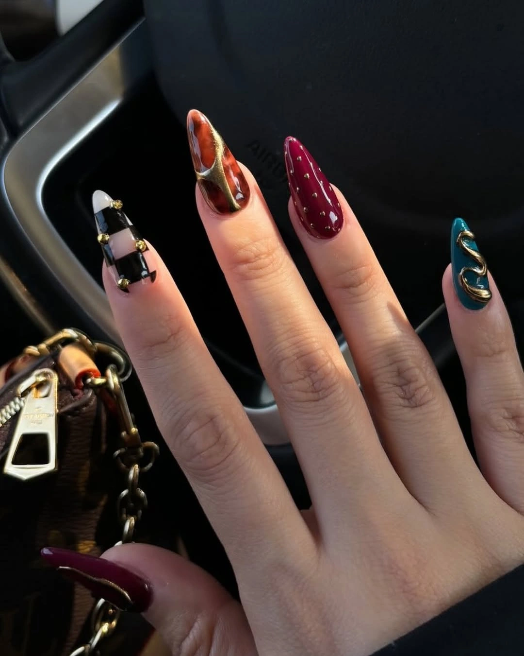 September nail designs 2026 Jewel Tone Almond Nails With Mixed Graphic Art