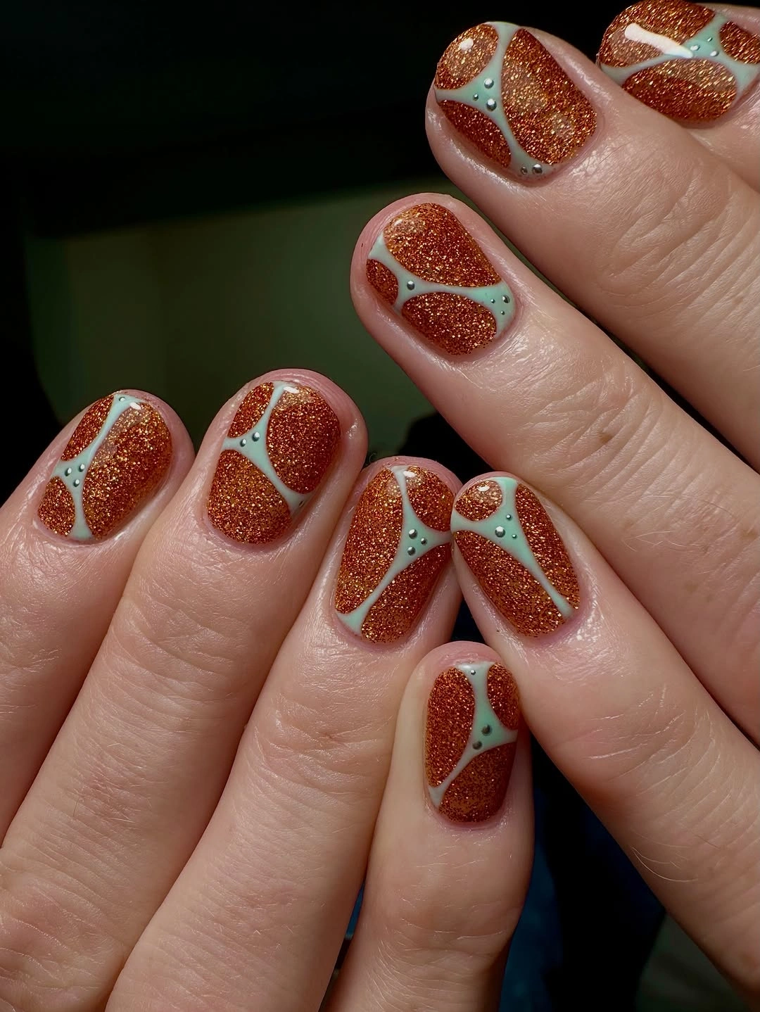 September nail designs 2026 Rust Glitter Short Nails With Petal Line Art
