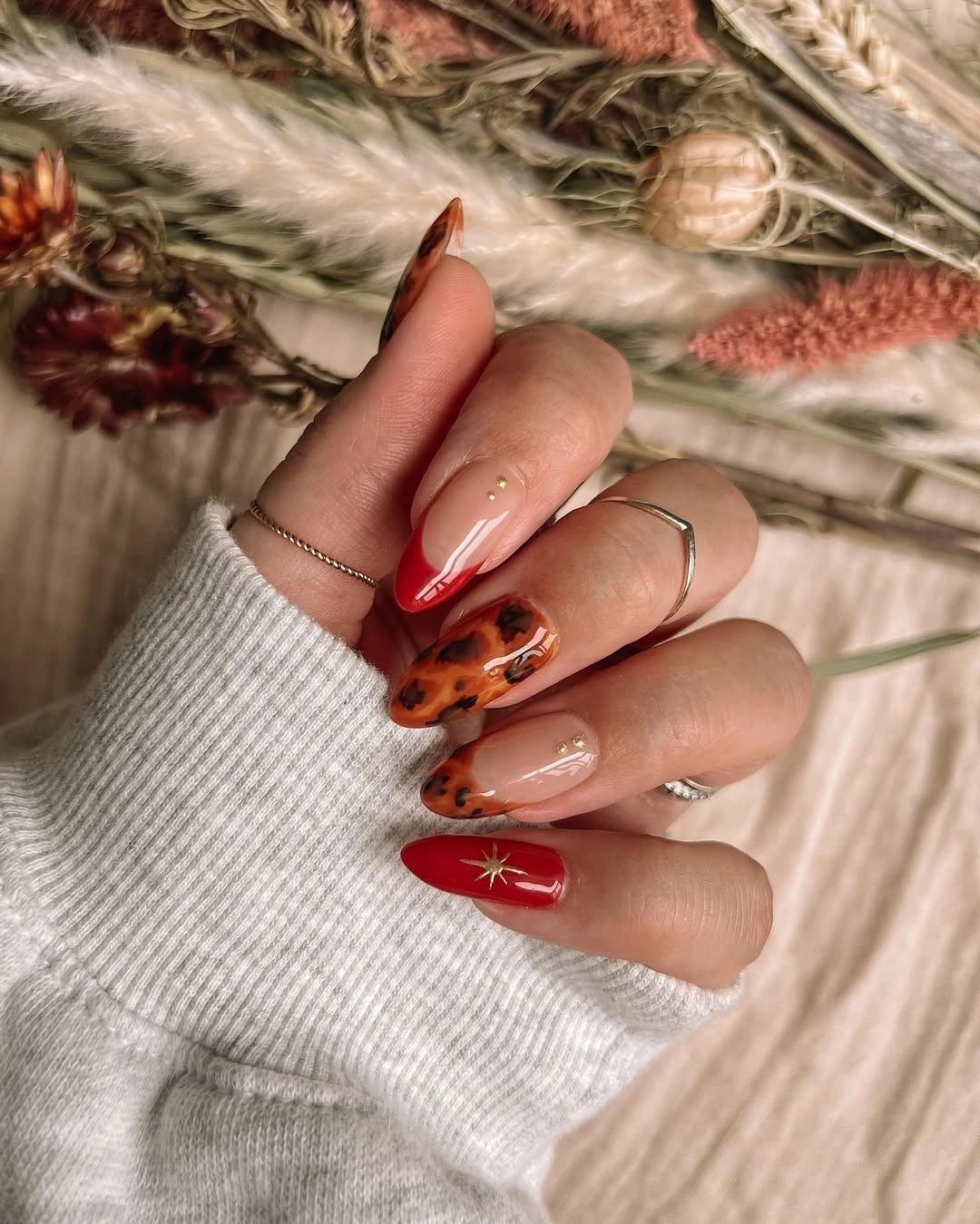 September nail designs 2026 Red Star Almond Nails With Tortoise Accent