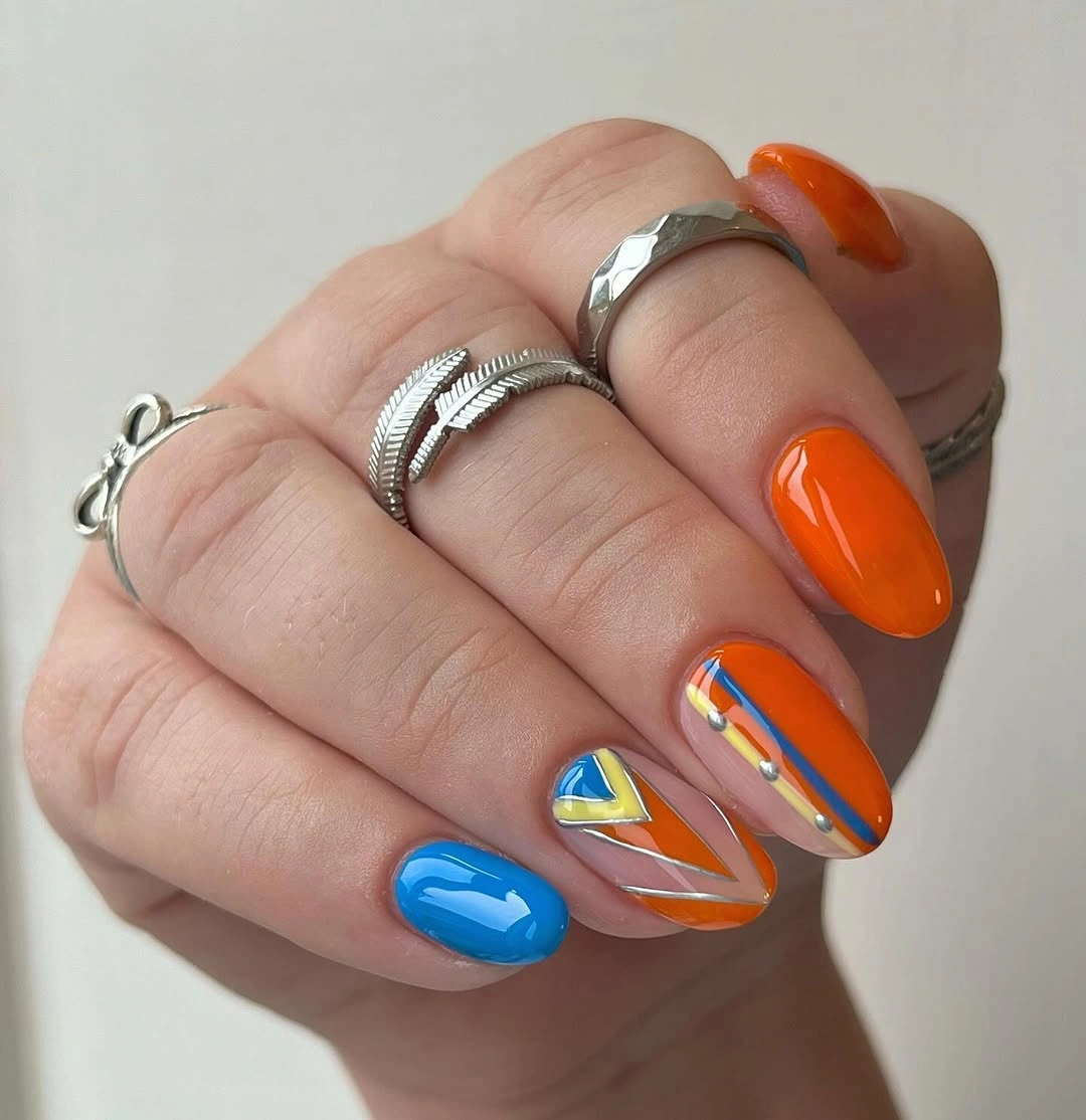 September nail designs 2026 Orange And Blue Short Nails With Graphic Stripes