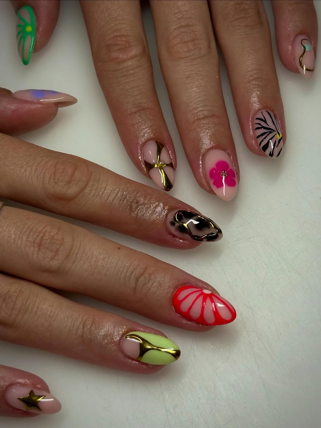 September nails color 2026 Mixed Floral Almond Nails With Green And Red Accents