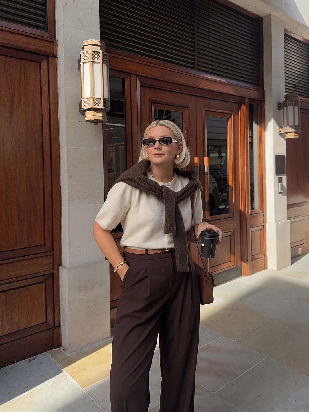 September outfits ideas 2026 Cream Sweater And Brown Trousers With Shoulder Tie