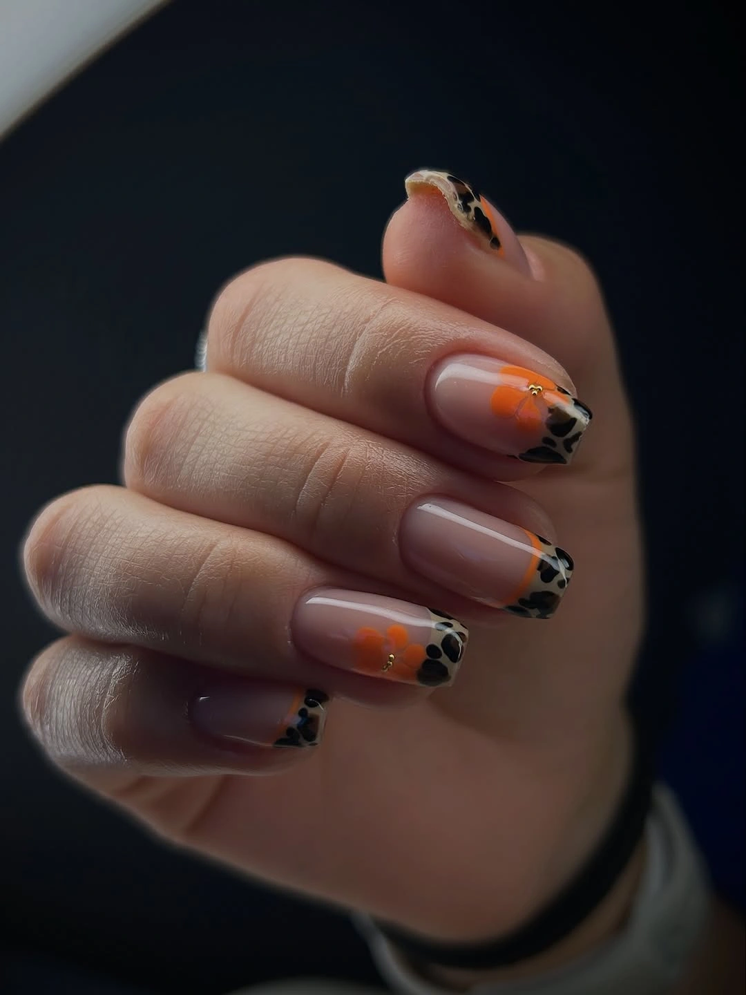 Medium almond nude autumn nails with dark tips and orange accents