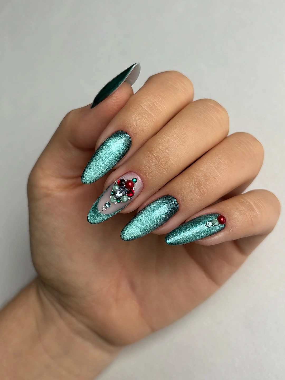 Long almond teal shimmer autumn nails with jeweled accents