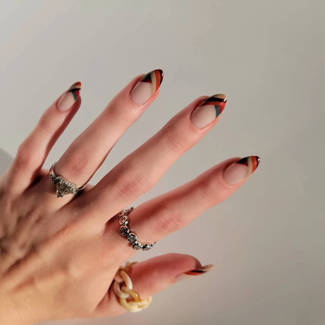 Medium almond nude autumn nails with curved dark tips