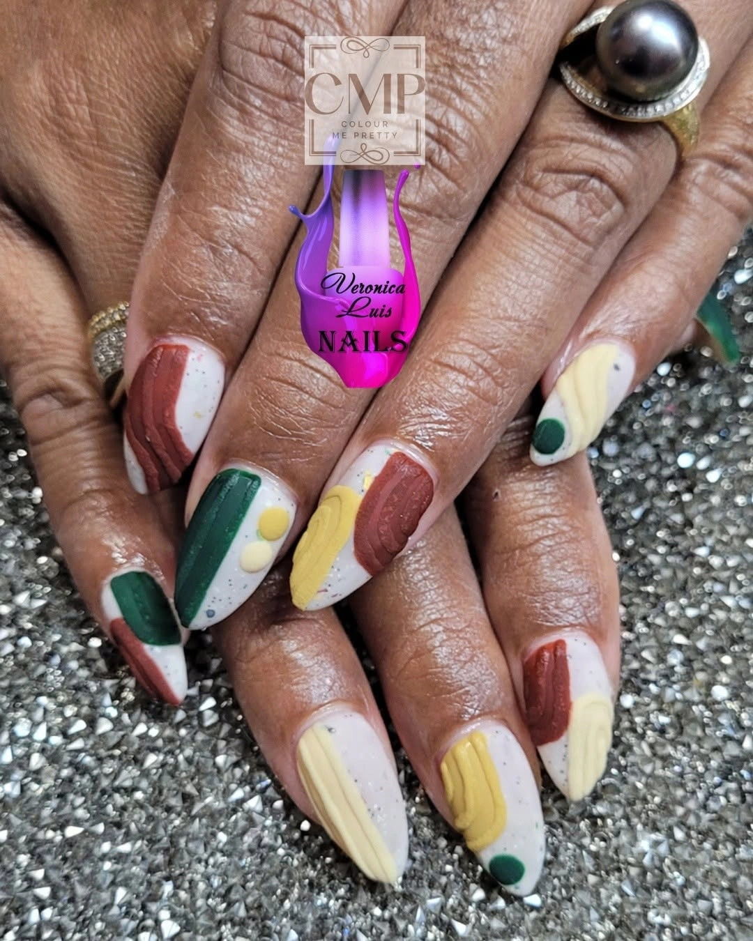 Long almond cream nails with green yellow and red accents