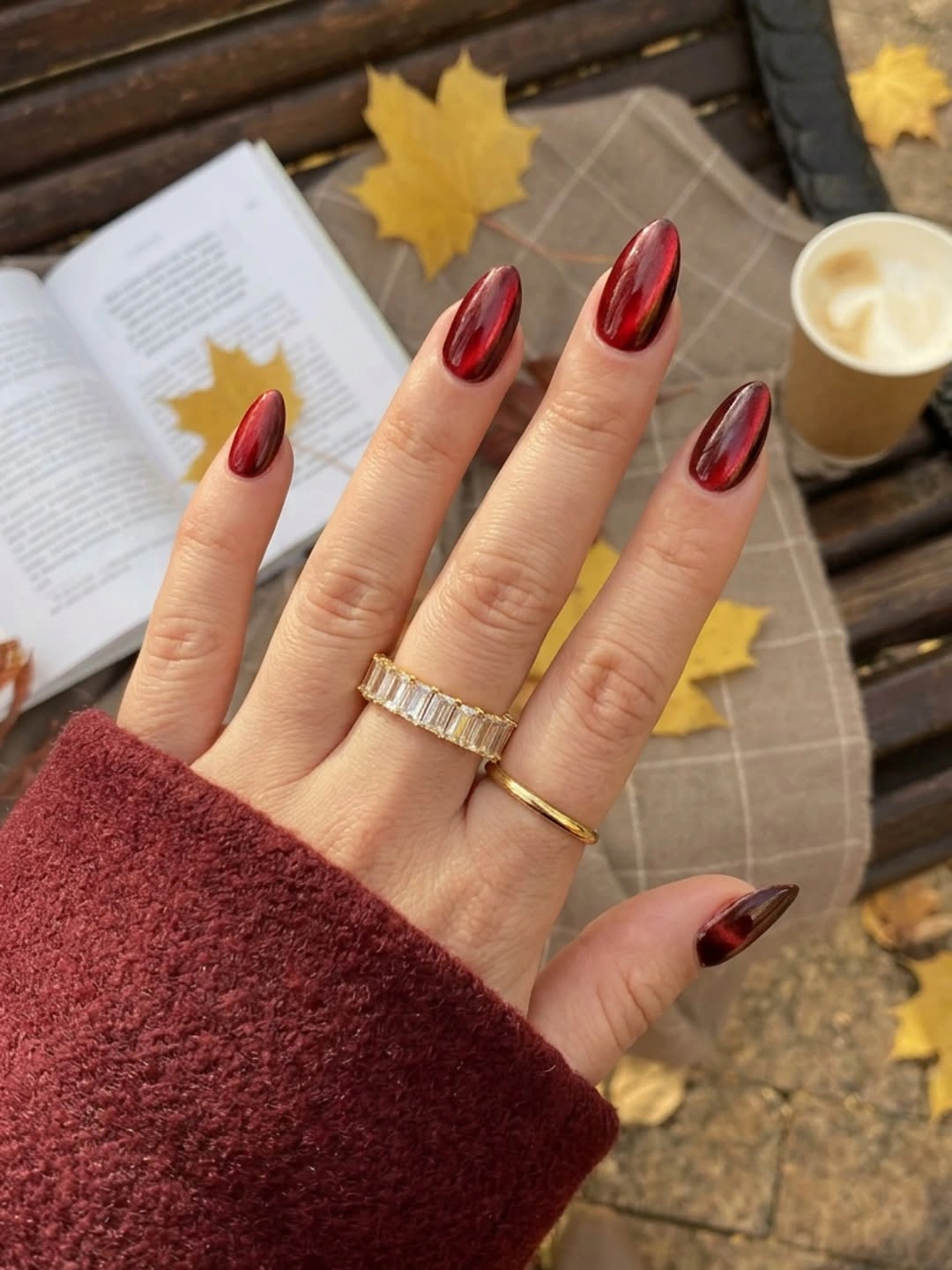Long almond deep burgundy autumn nails in a seasonal setting