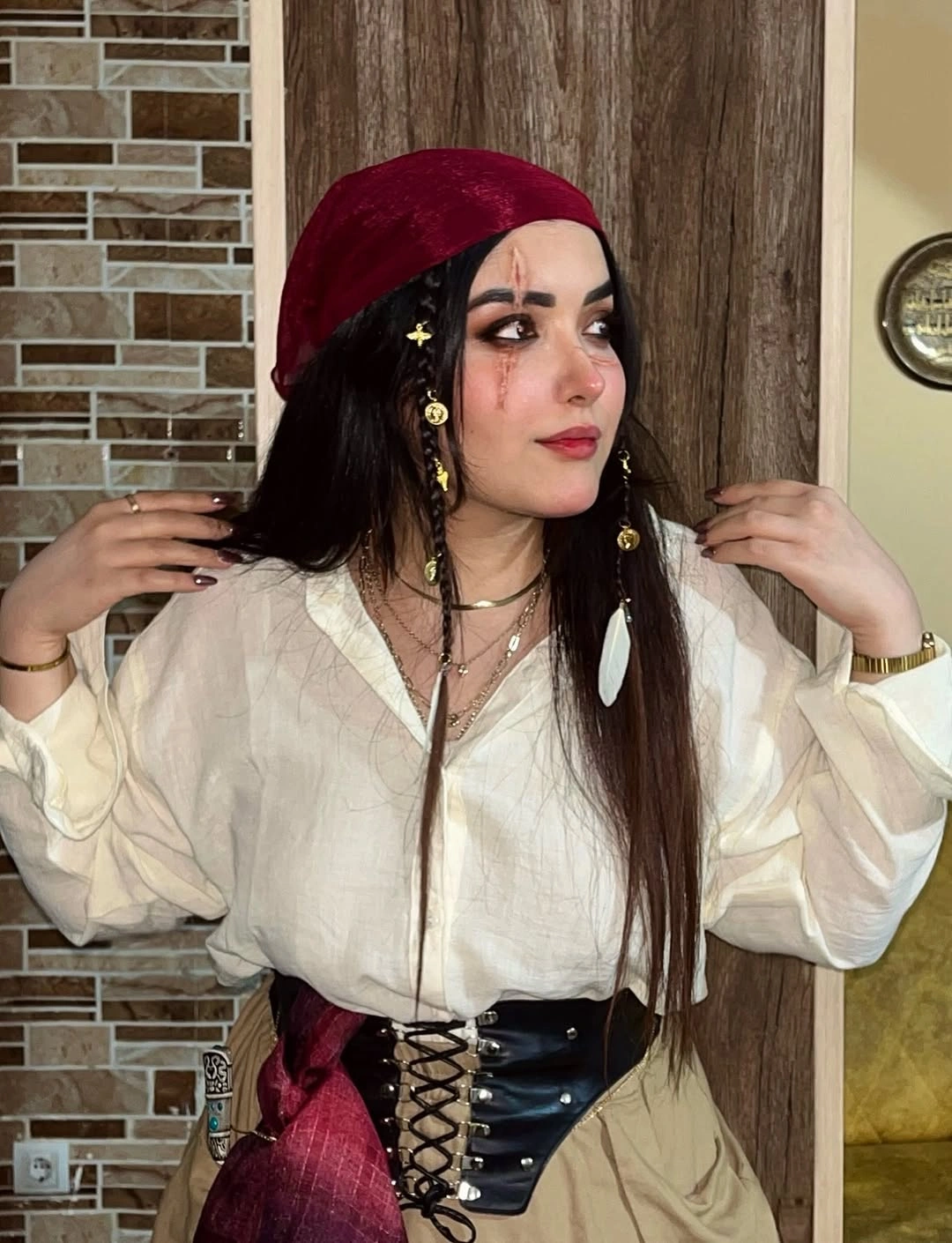 Pirate-inspired costume with ivory blouse burgundy beret and black corset belt