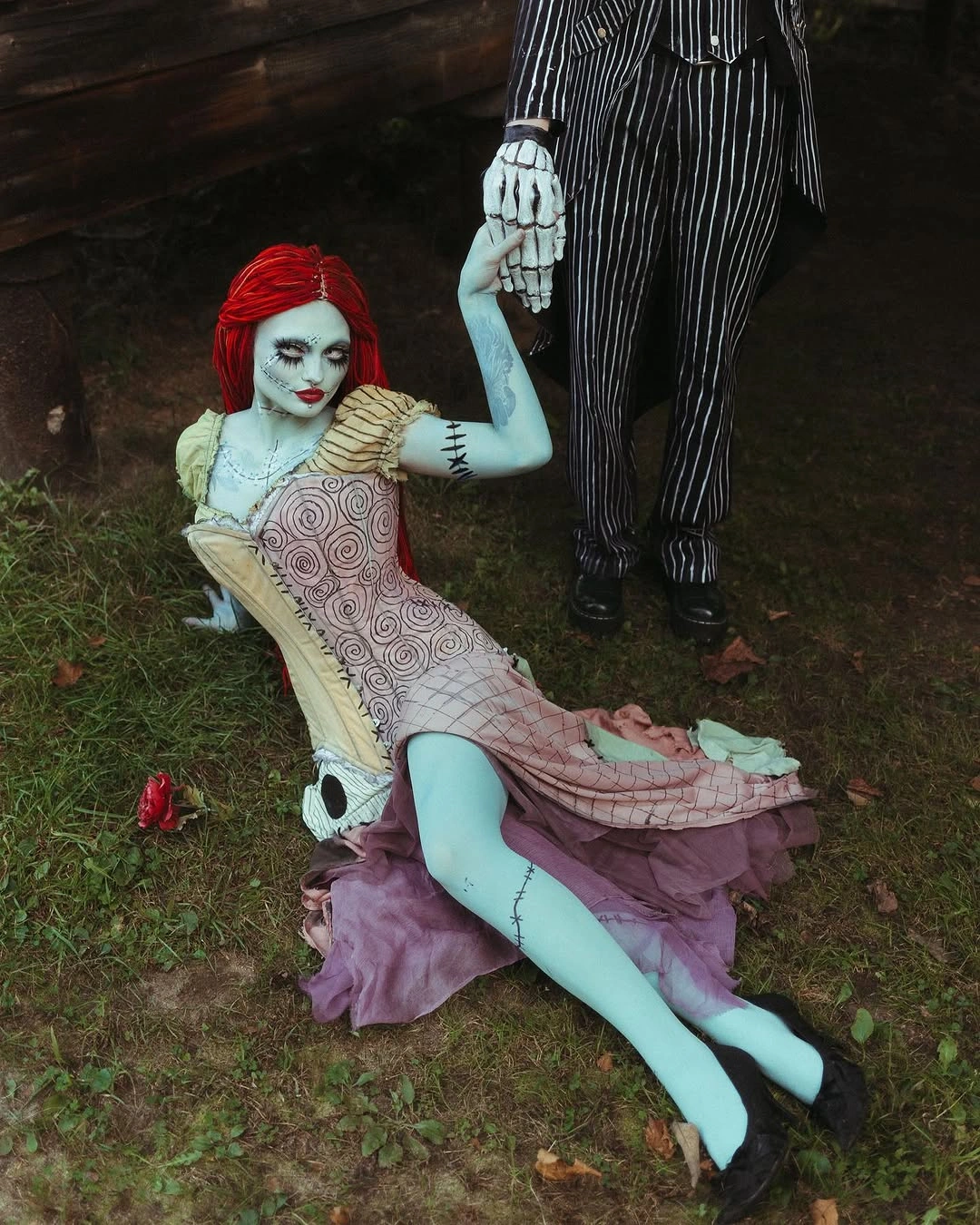 Patchwork rag-doll costume with red yarn-style hair and striped stockings