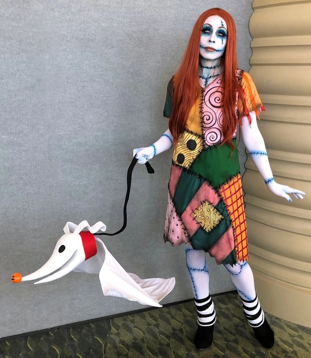 Patchwork rag-doll costume with striped socks red yarn-style hair and ghost prop