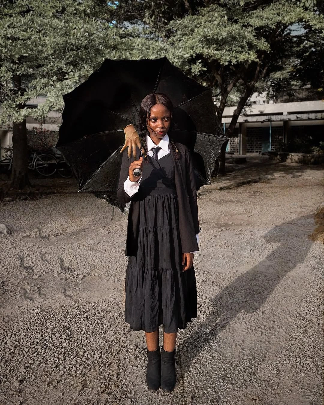 Black witchy dress costume with dark tights ankle boots and parasol