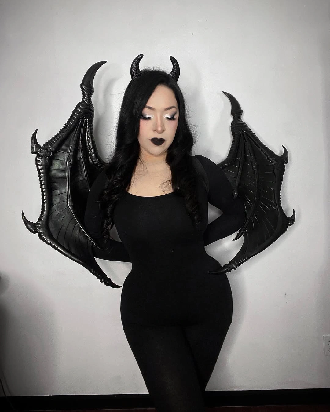 Black horned wing costume with fitted jumpsuit structured wings and dark makeup