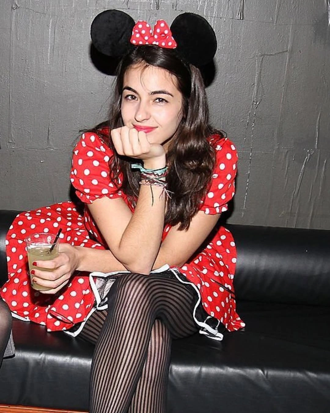 Red polka-dot mouse-inspired dress with black ear headband and striped tights