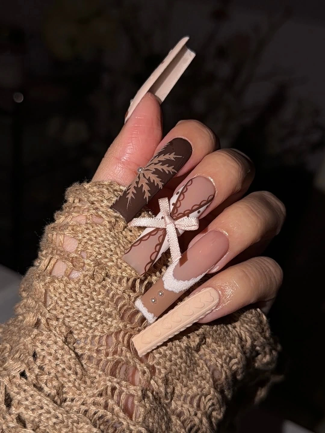 Long coffin blush and brown nails with ornate curved line art