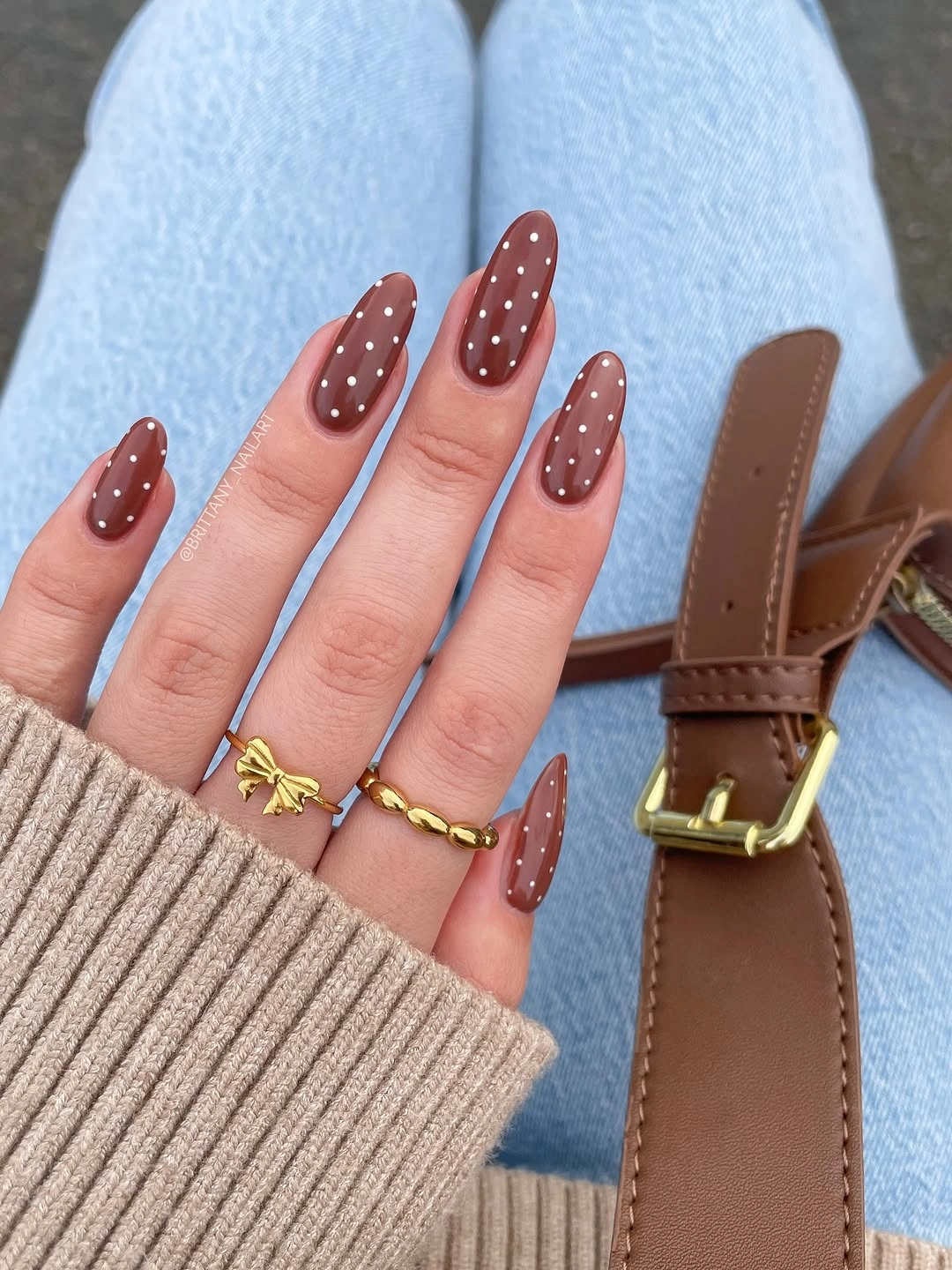 Long almond dusty rose nails with white dots and gold star accents