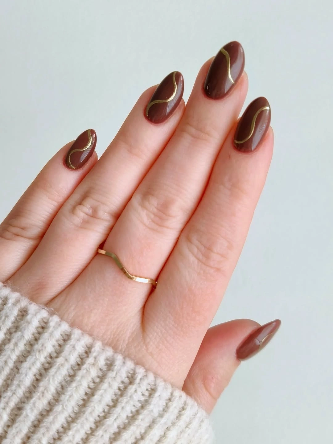 Medium almond nude nails with chocolate brown outlined edges