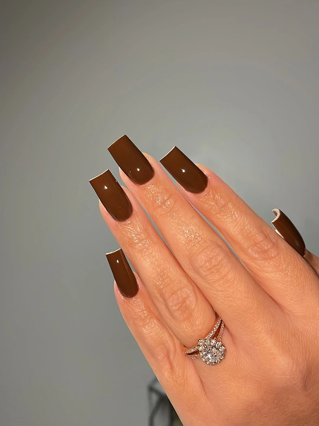 Medium square nails covered in glossy deep chocolate brown