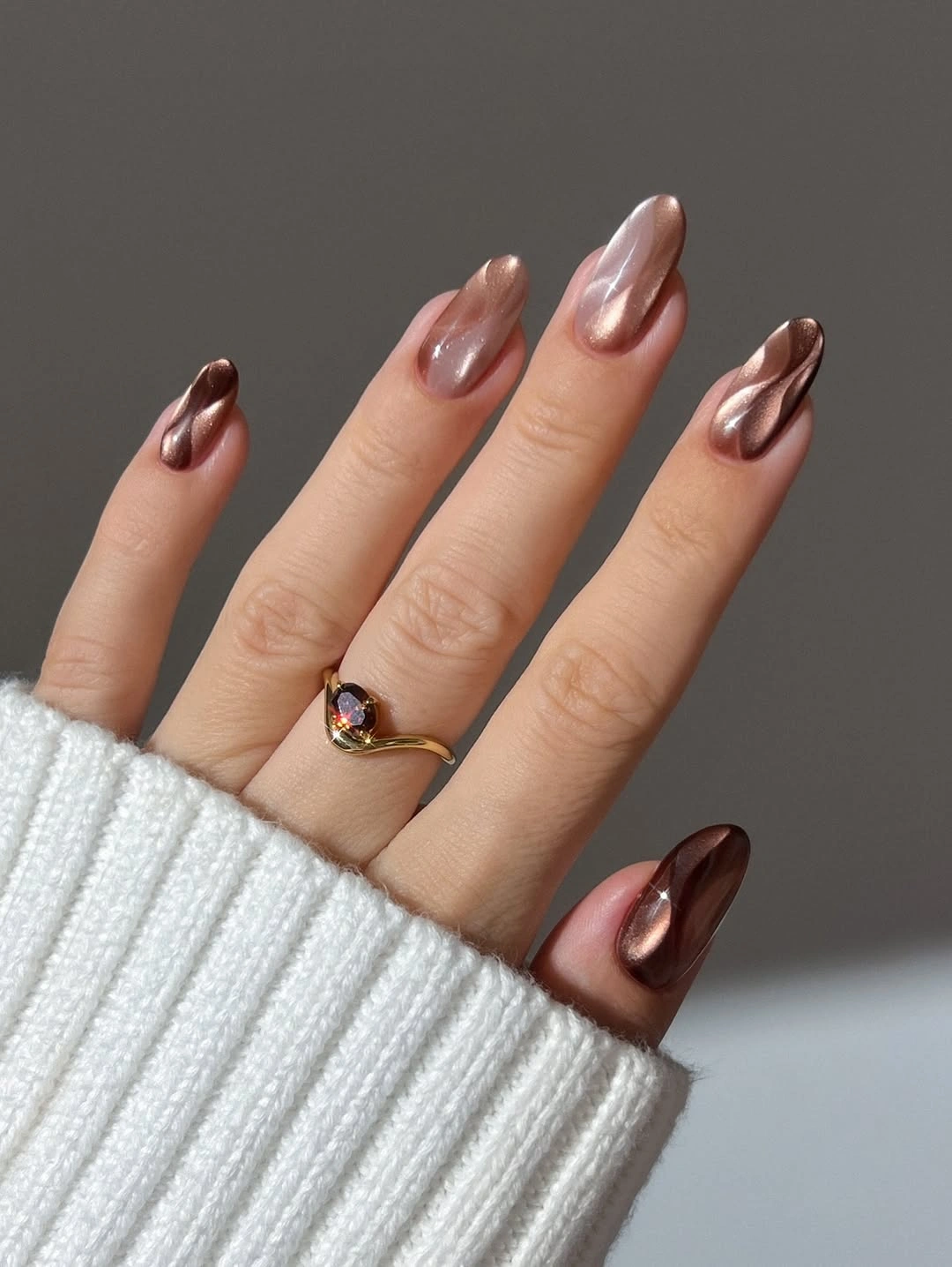 Long almond nude nails with narrow reflective brown edges