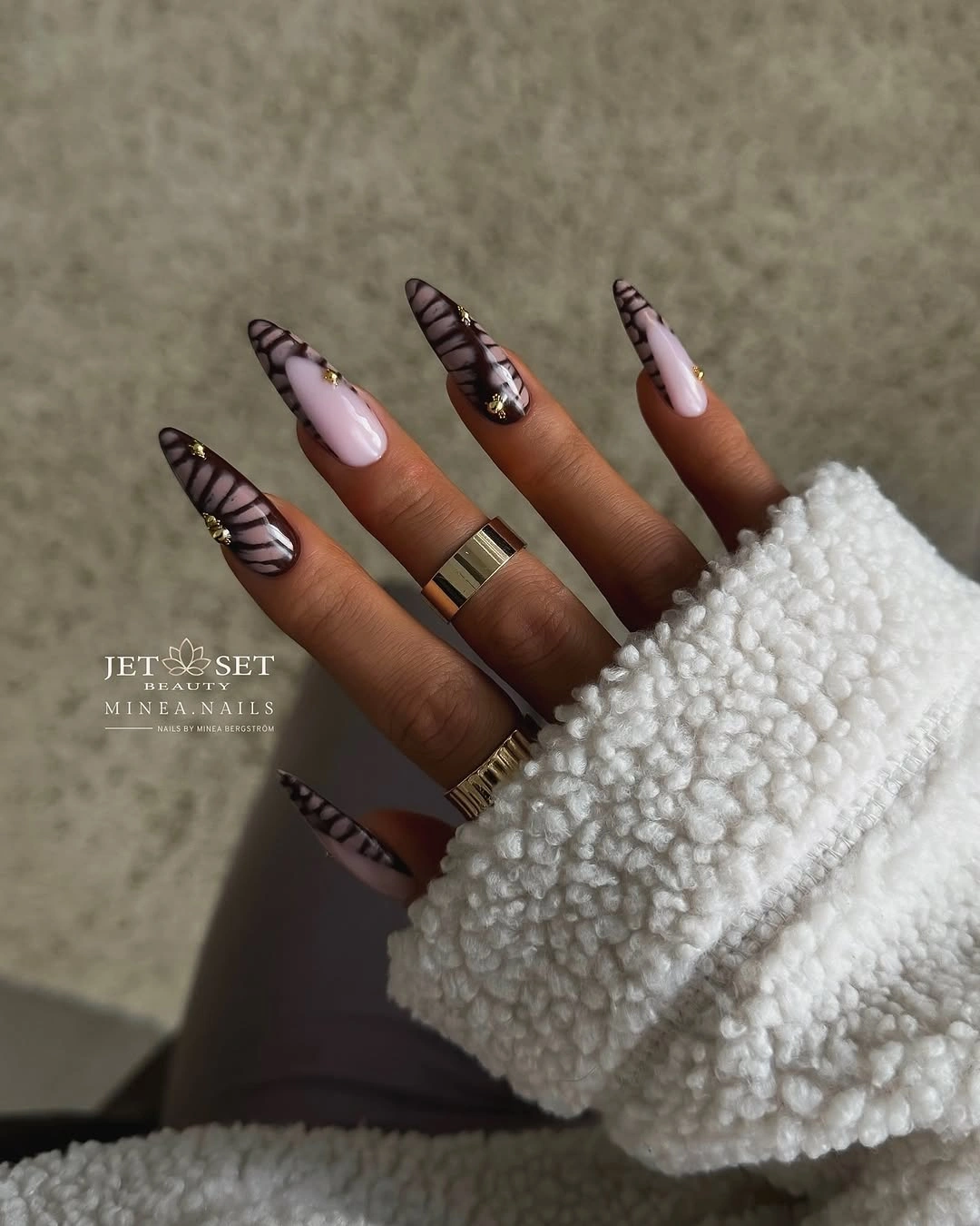 Long stiletto nails in brown pink and cream with striped accents